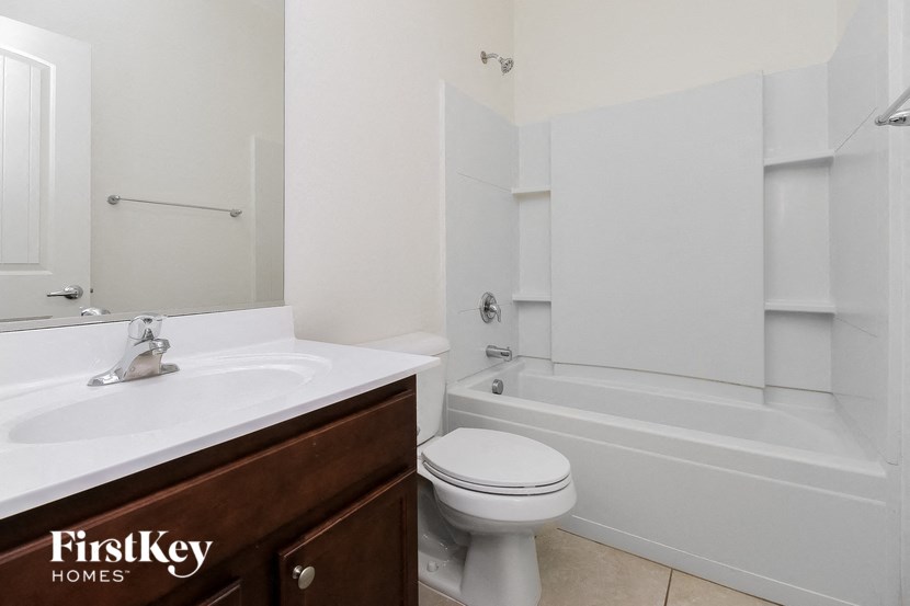 a bathroom with a sink toilet and a bath tub