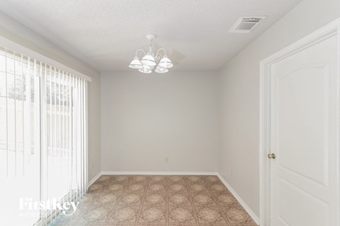 A room with a tiled floor and a door.