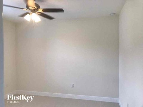 a white room with a ceiling fan
