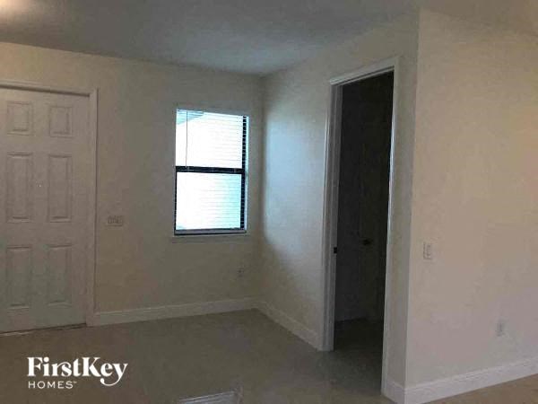 an empty room with a window and a door