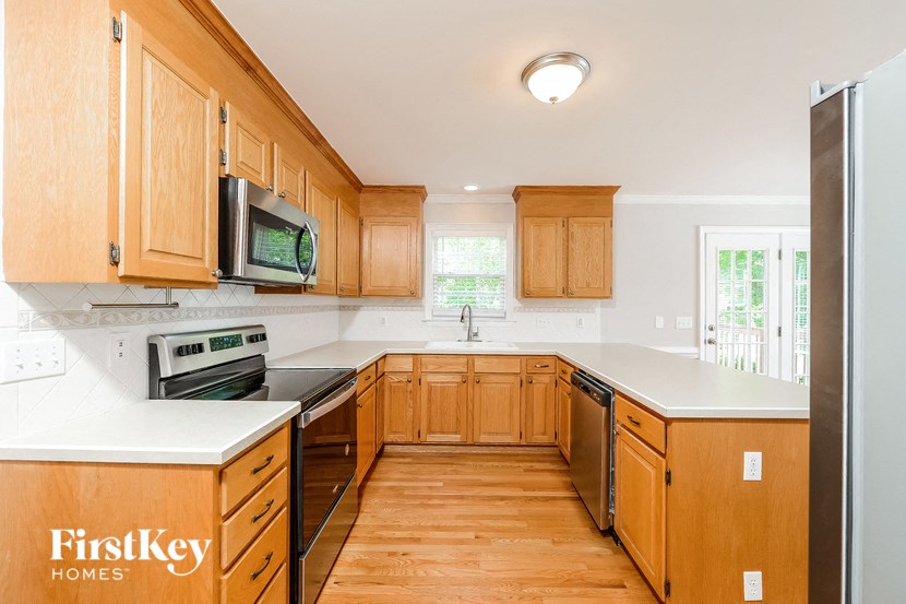 a kitchen with wooden cabinets and white counter tops