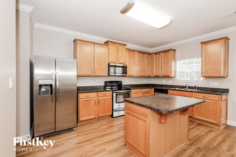 a kitchen with wooden cabinets and stainless steel appliances