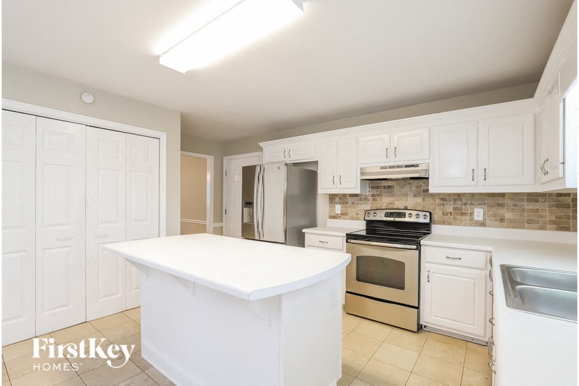 a kitchen with white cabinets and a white counter top