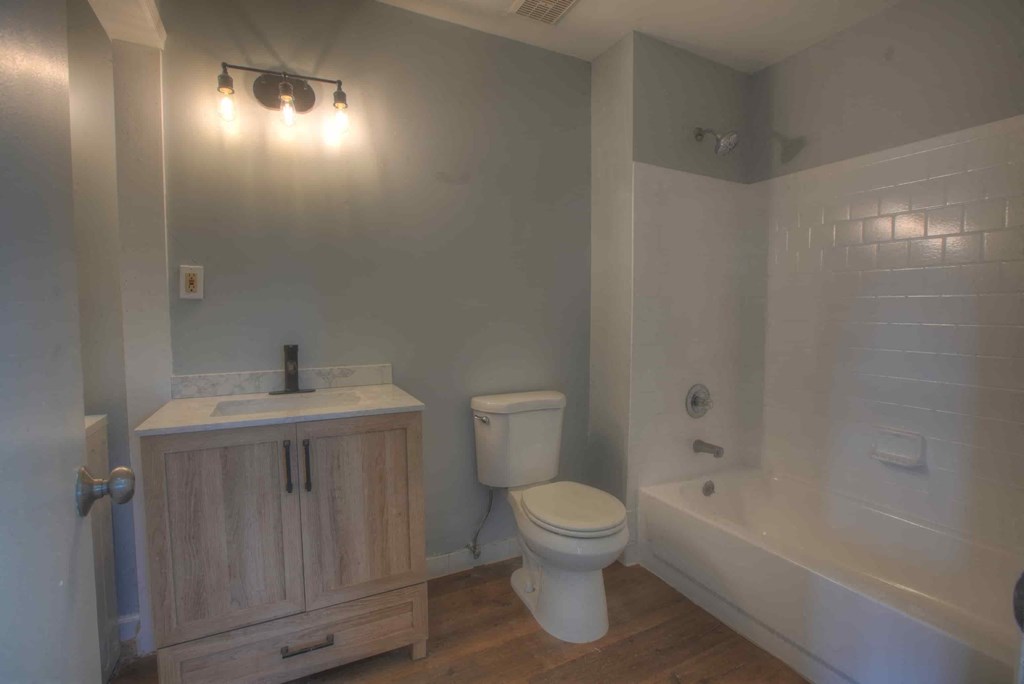a bathroom with a toilet and a sink and a tub