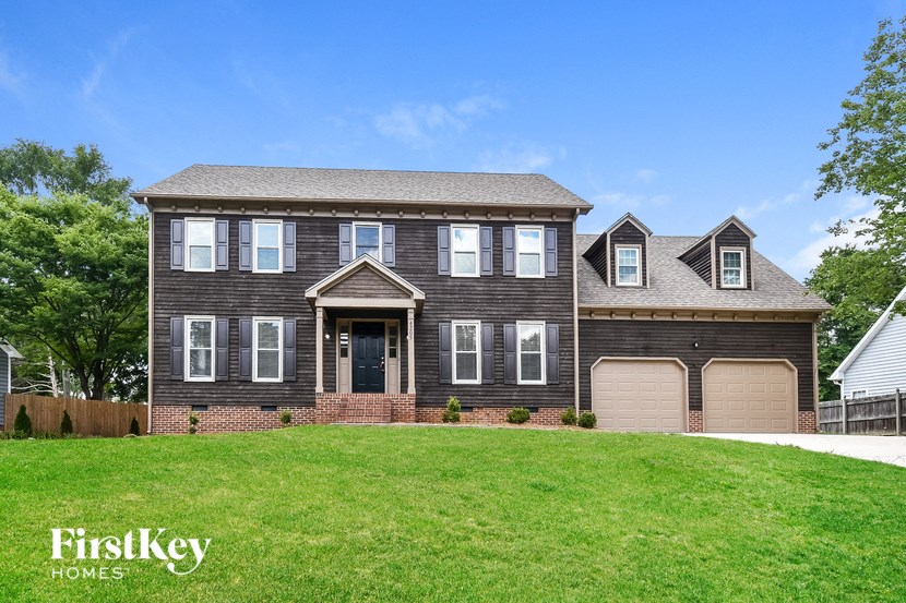 a large house with a lawn in front of it