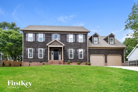 a large house with a lawn in front of it