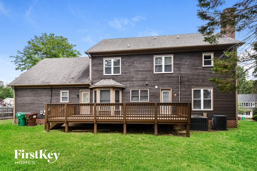 a wooden house with a deck and a yard