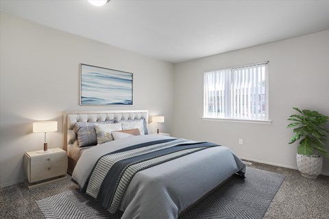 A bedroom with a large bed and a painting on the wall.