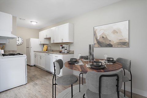 A modern kitchen with a dining table set for four.