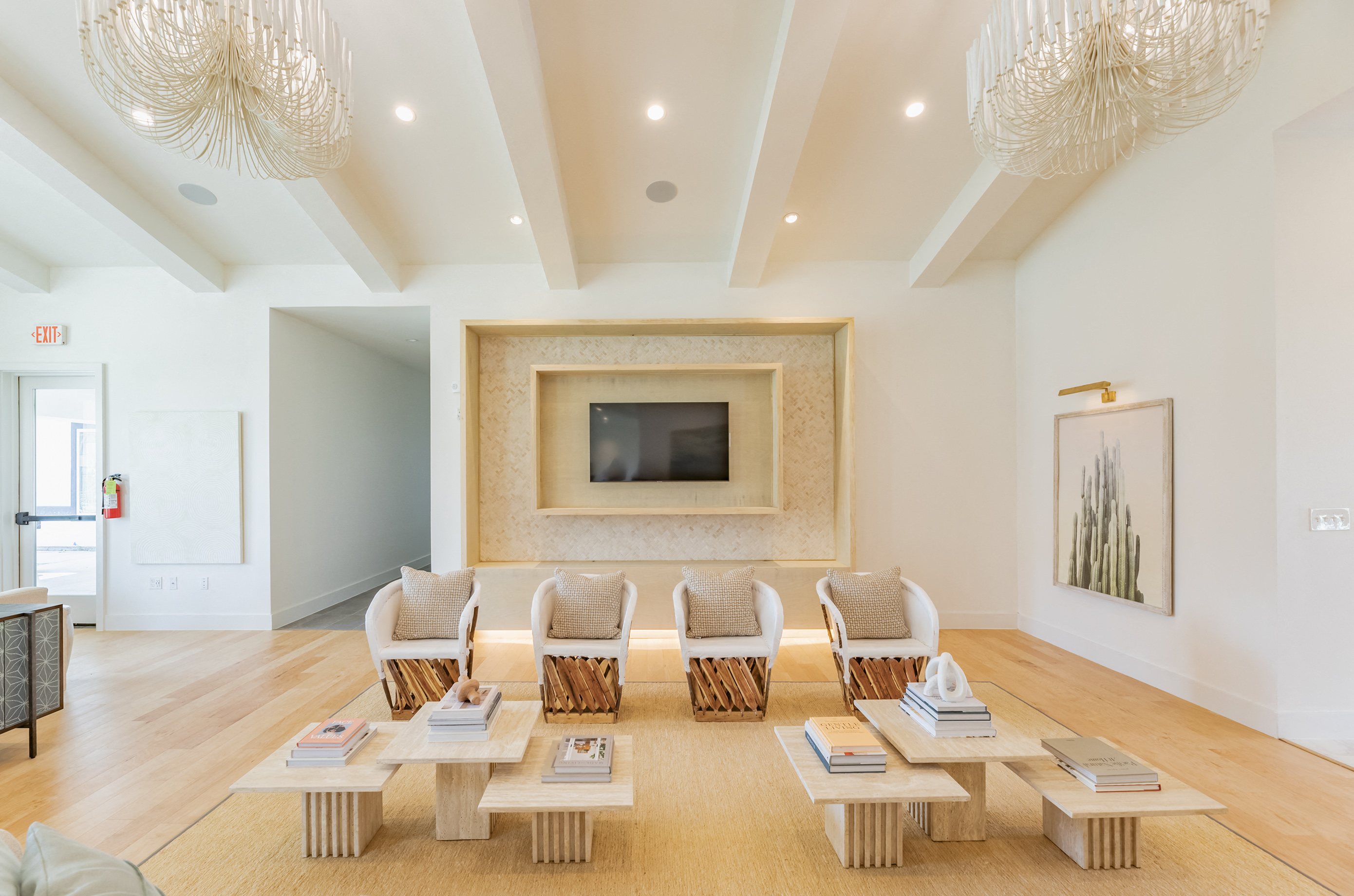 a living room with chairs and tables and a fireplace
