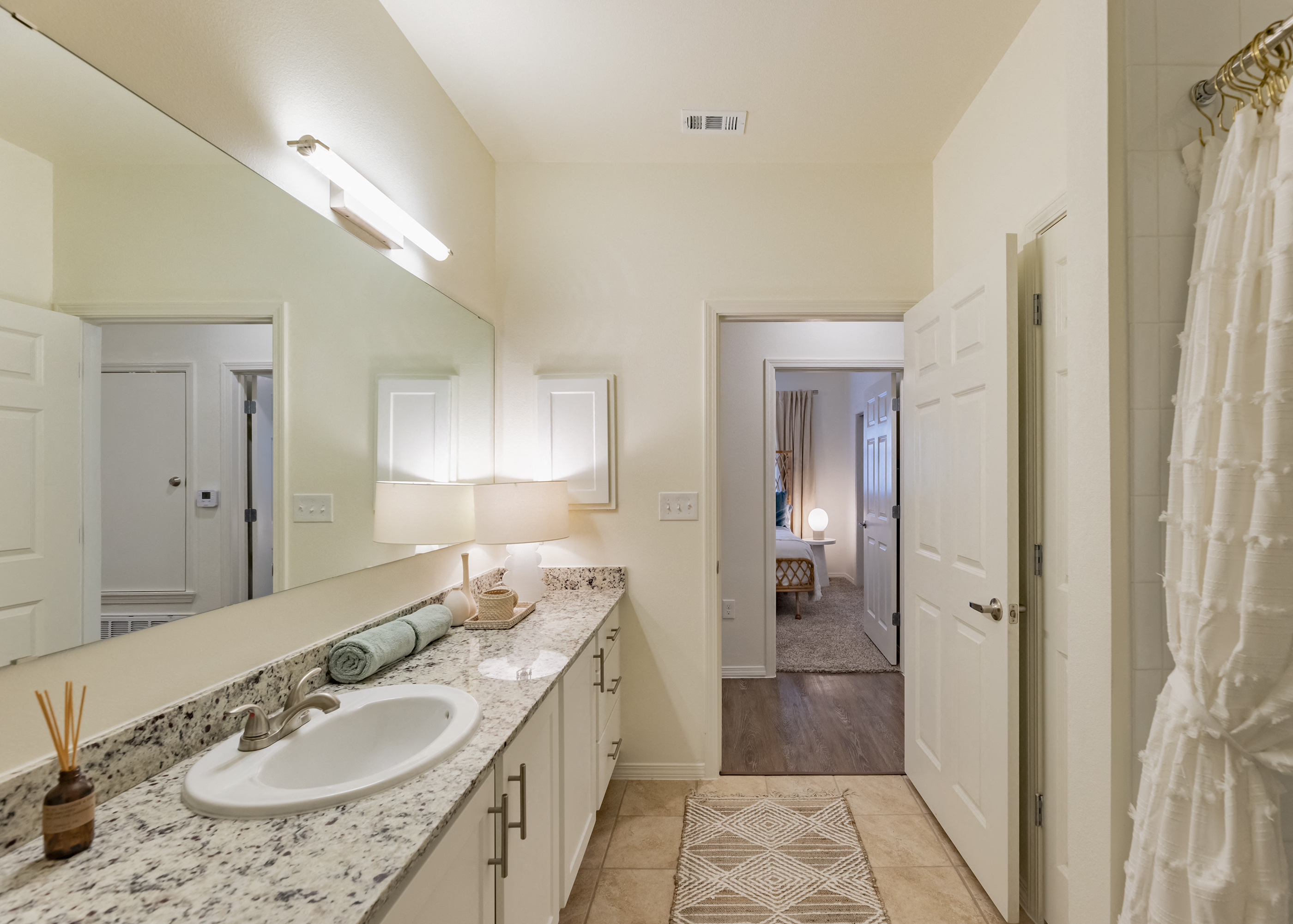 a bathroom with a sink and a mirror and a closet