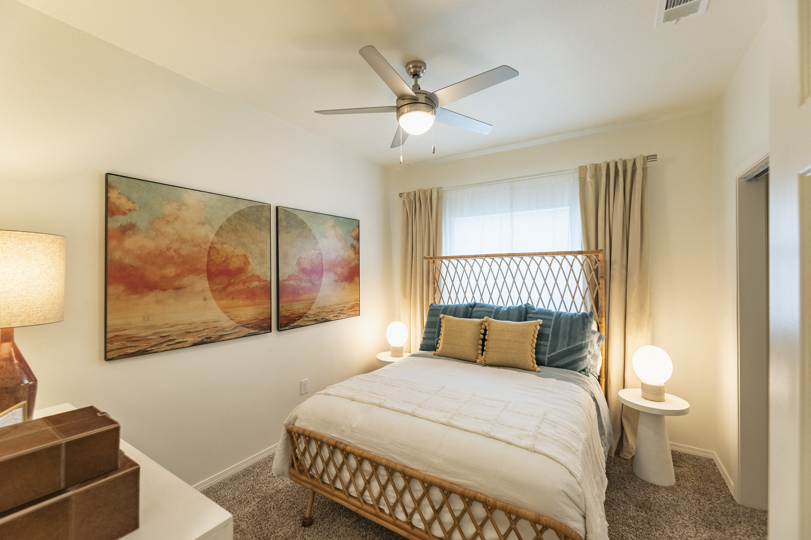 a bedroom with a bed and a ceiling fan