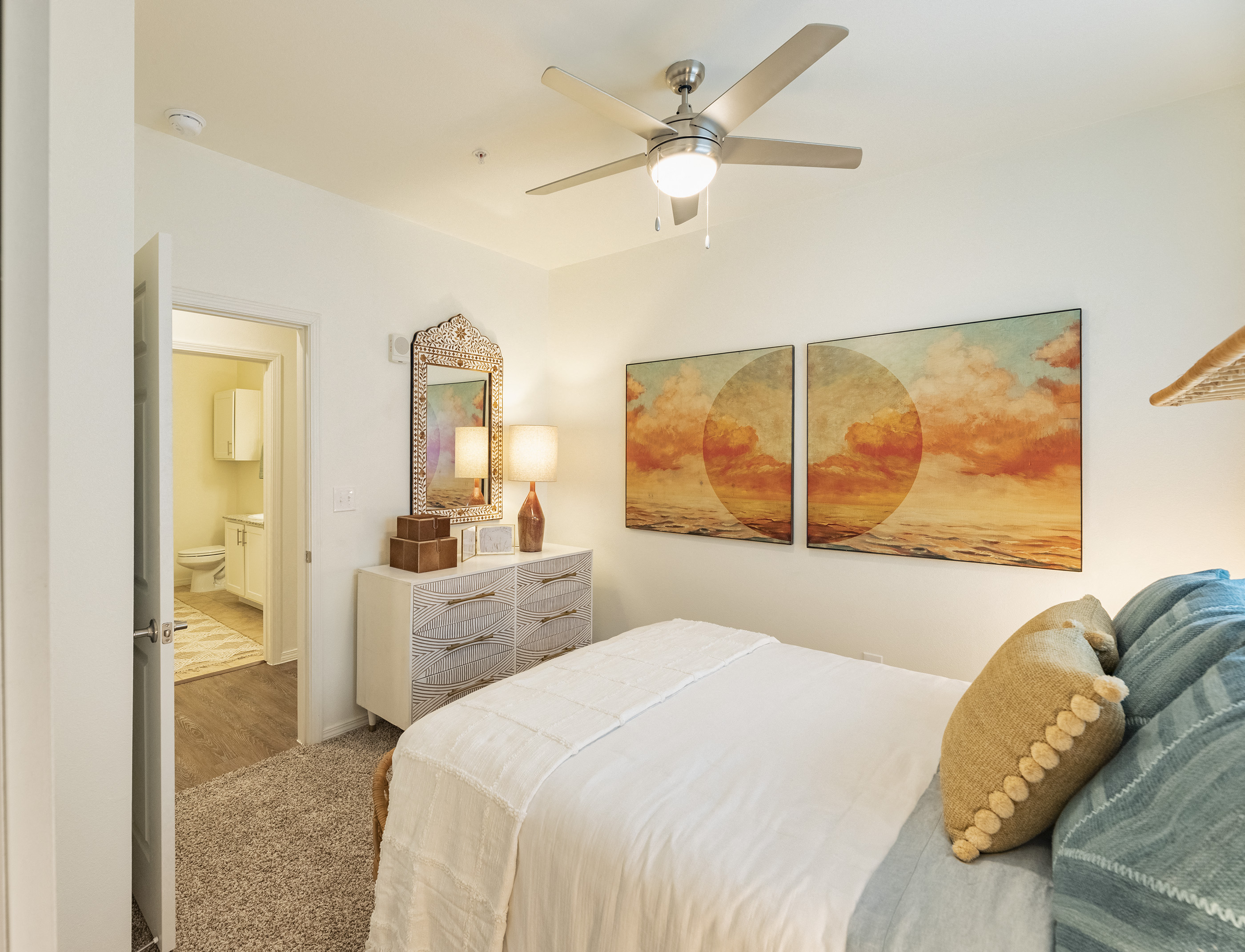 a bedroom with a bed and a ceiling fan