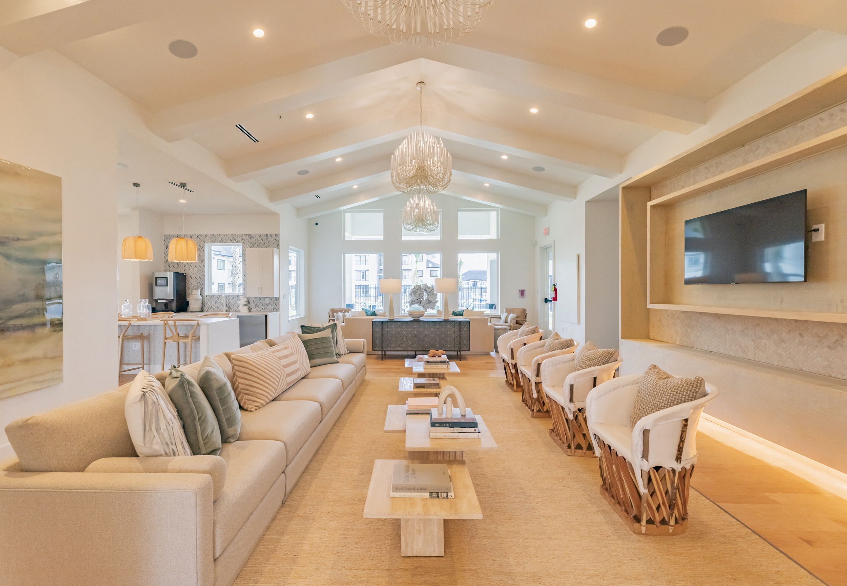 a living room with couches and chairs and a television