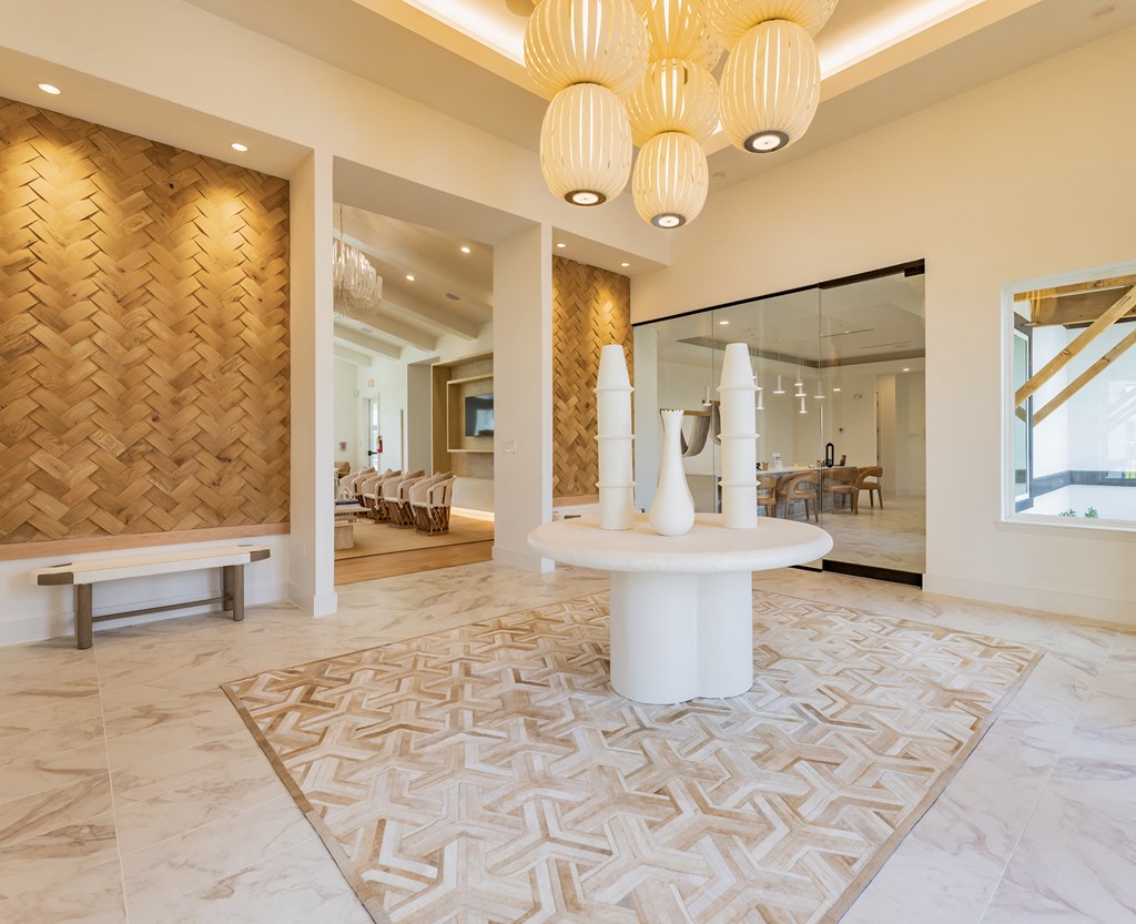 a reception room with a white table and a geometric rug