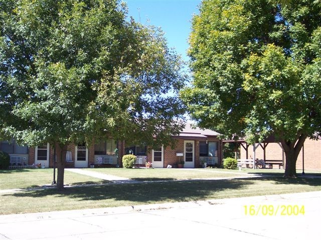 a brick building with trees in front of it