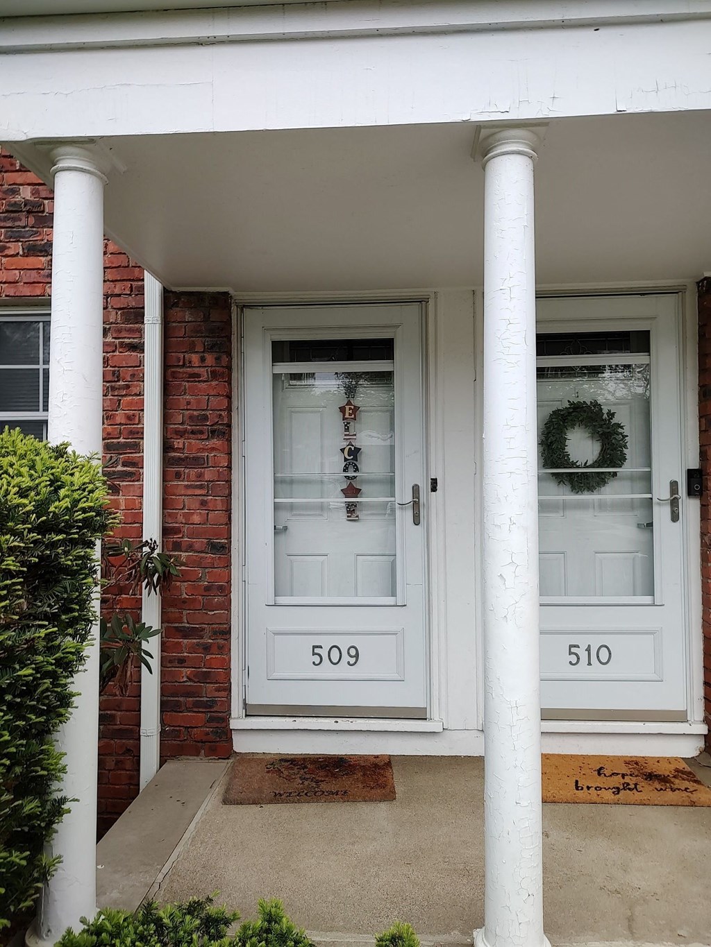 the front door of a brick house with a white door