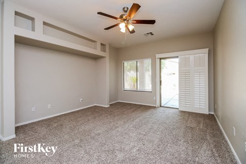 the master bedroom is spacious and has a closet and a ceiling fan