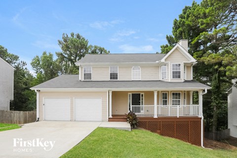 A two-story house with a garage and a porch.