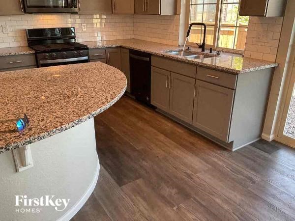 a kitchen with a granite counter top and a sink
