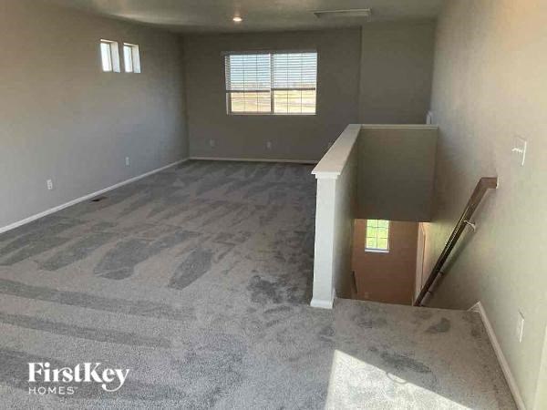 an empty room with a staircase and a box on the floor
