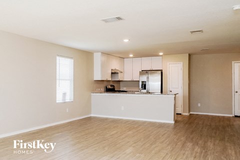 A kitchen area with a white counter and cabinets.