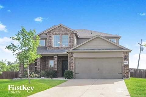 a house with a garage door and a lawn