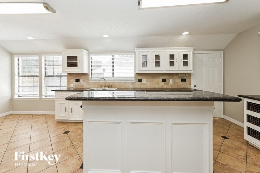 a kitchen with white cabinets and a counter top