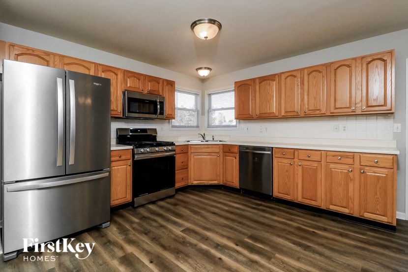 a kitchen with wooden cabinets and stainless steel appliances
