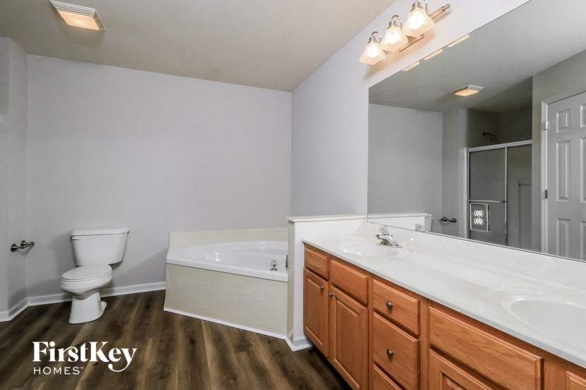 a bathroom with a toilet sink and a tub and a mirror