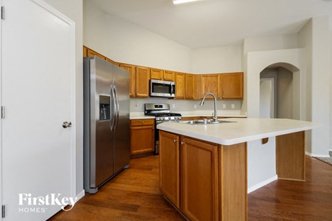 A kitchen with wooden cabinets and a white countertop.