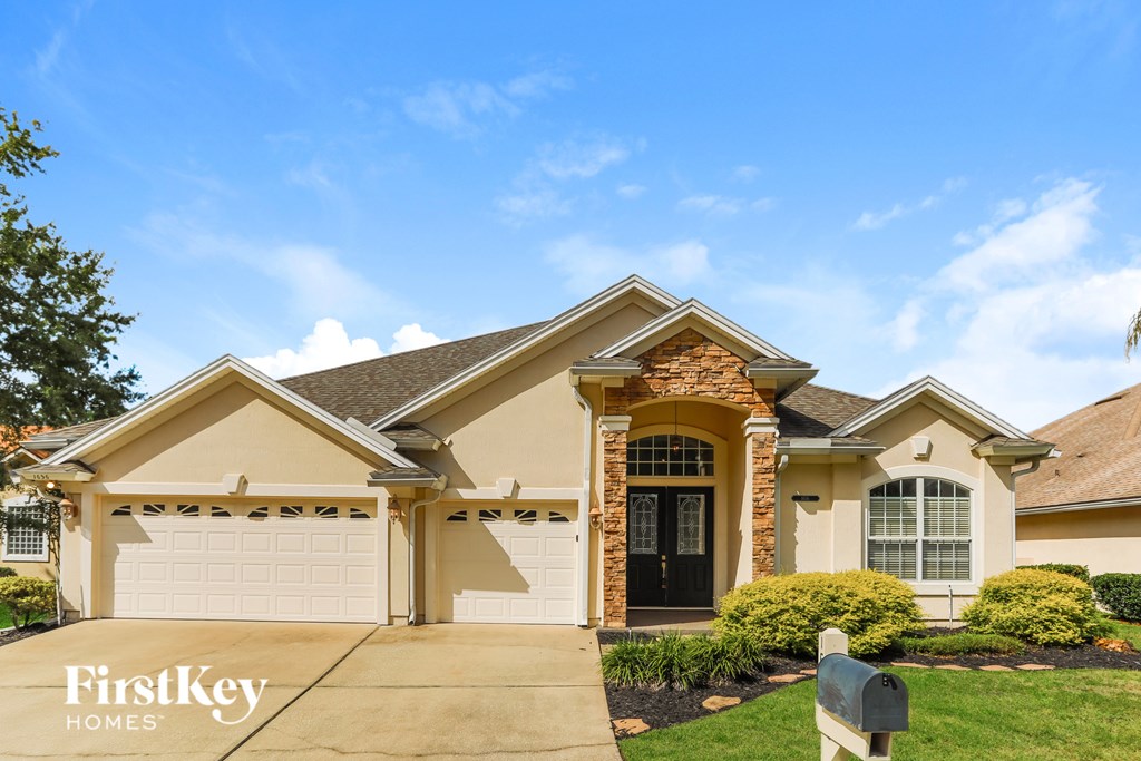 A house with a brown roof and a white garage door is for sale.