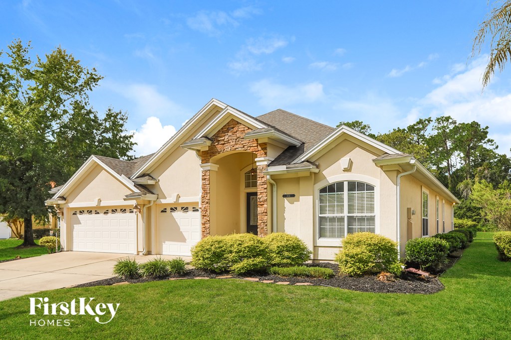 A house with a well-maintained lawn and a clear sky.