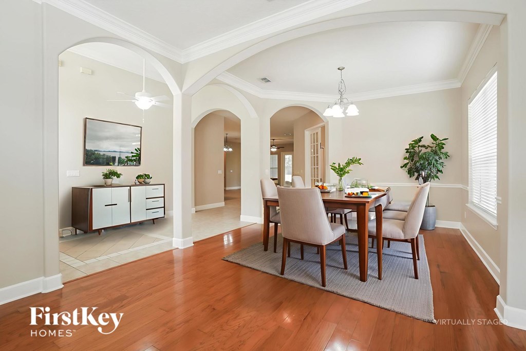 A dining room with a wooden table and chairs.