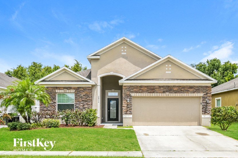 a house with a palm tree in front of it