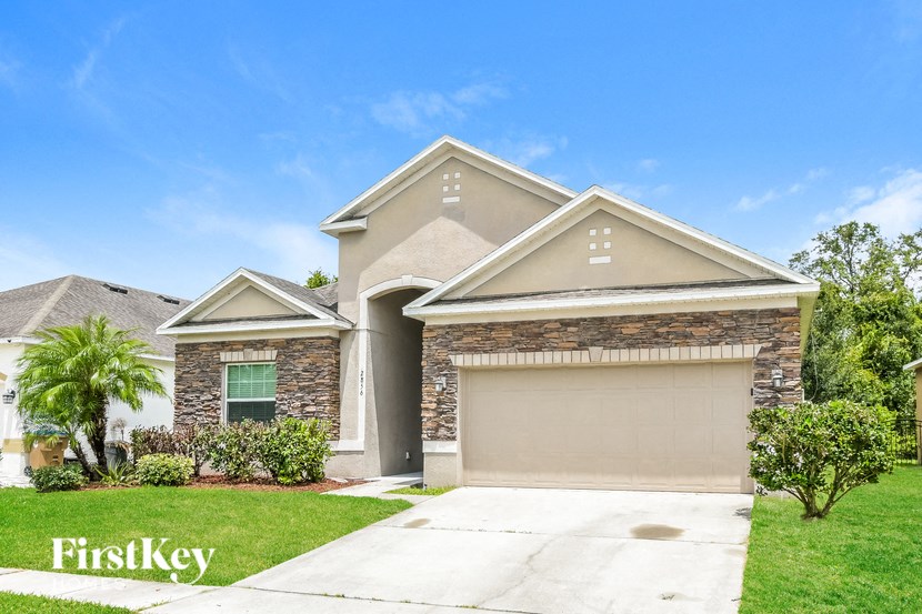 a house with a driveway and a garage door
