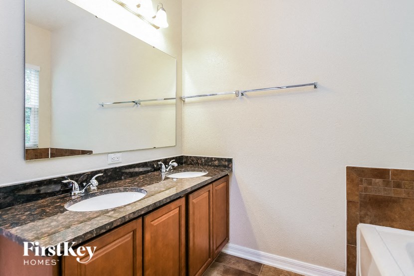 a bathroom with two sinks and a large mirror