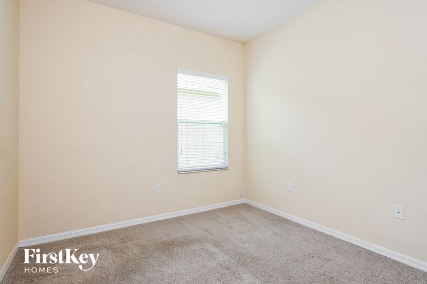 a room with a carpeted floor and a window
