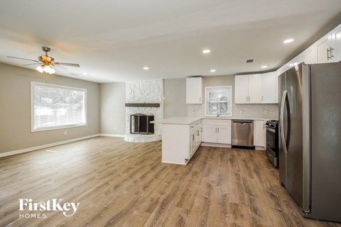 a kitchen with white cabinets and a stainless steel refrigerator