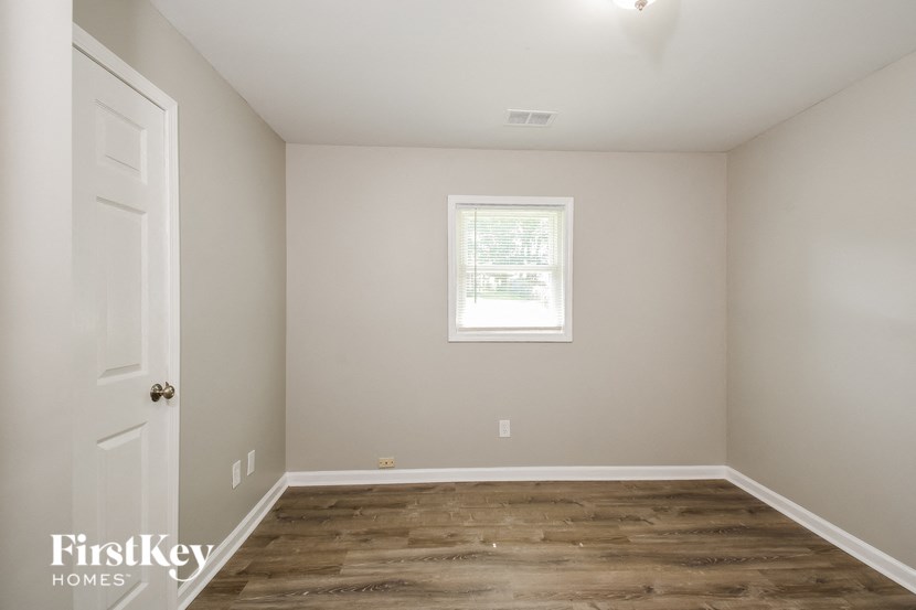 a empty room with a white door and a window