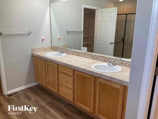 a bathroom with two sinks and a mirror