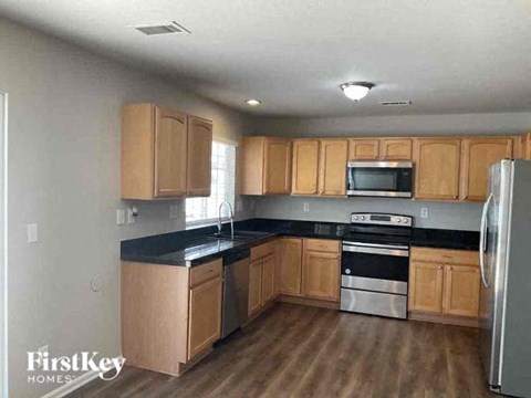 a kitchen with wooden cabinets and stainless steel appliances