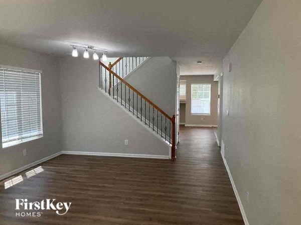 an empty living room with a staircase