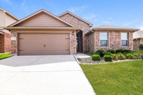 A house with a brown garage door is for sale.