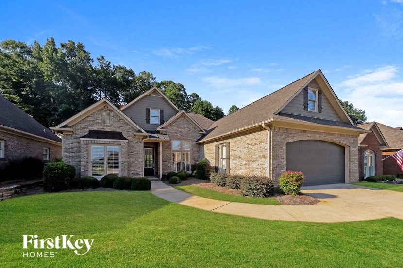 A large house with a driveway in front of it.