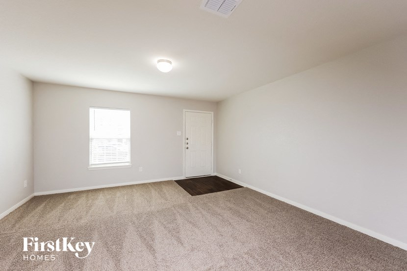 a white room with carpet and a white door