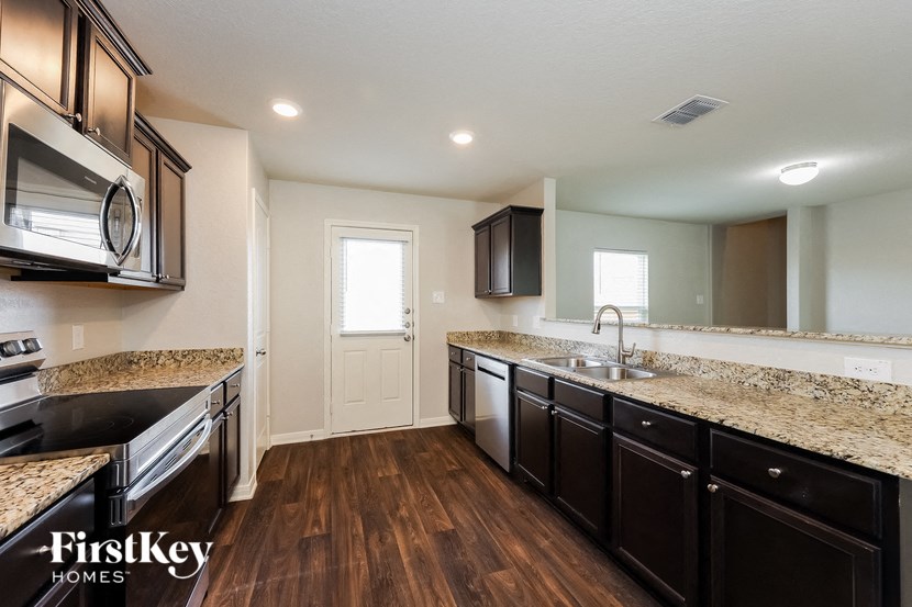 a kitchen with granite counter tops and stainless steel appliances