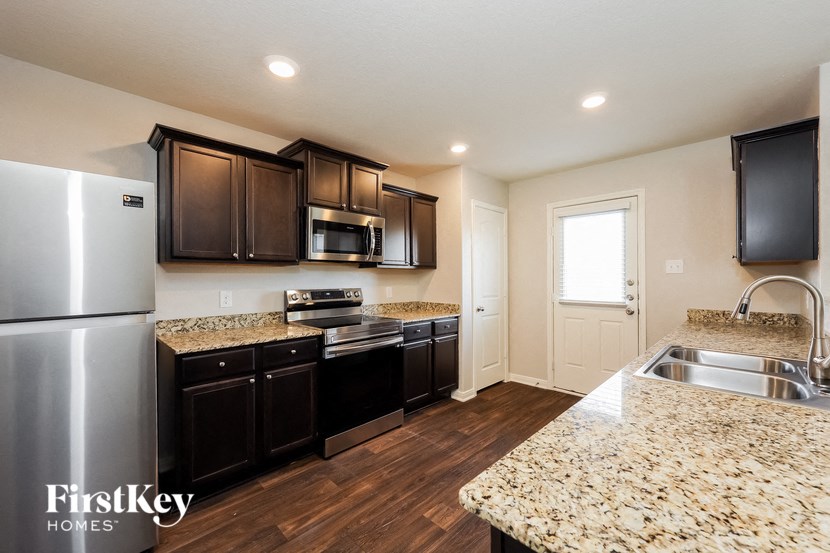 a kitchen with stainless steel appliances and granite counter tops