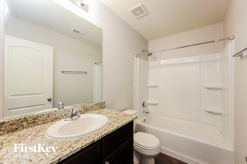 a bathroom with a sink toilet and a shower