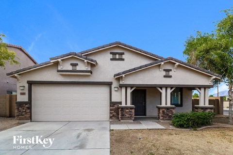 a home with a garage door and a driveway